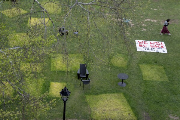 Squares mark a lawn where tents once stood after an encampment protesting the Israel-Hamas war was taken down at Brown University, Tuesday, April 30, 2024, in Providence, R.I. Brown University administrators and leaders of several student groups on Tuesday said a deal would end a protest there by evening. The statements said President Christina Paxson had committed to an October vote by the school's governing board on the students' divestment proposal. (AP Photo/David Goldman)